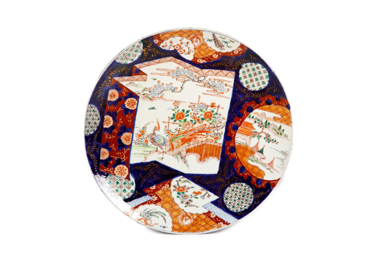 IMARI CHARGER WITH PHEASANTS: Japanese, late Meiji period, with asymmetrical panel decoration, featuring pheasants in centre; the verso with underglaze blue floral motifs. Dia. 55.6 cm. (21.8 in.)