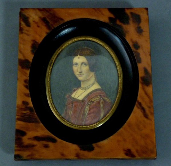 HAND PAINTED PORTRAIT MINIATURE OF A WOMAN: Hand painted portrait miniature of Lucrezia Crivelli in a tortoiseshell and ebonized frame. 19th century. Height of portrait 7.3 cm (2 7/8").