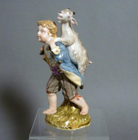 MEISSEN FIGURE OF A BOY AND A GOAT: Meissen figure of a boy and a goat. Crossed sword mark with dot between blades. 20th century. H 15.5 (6 1/8").