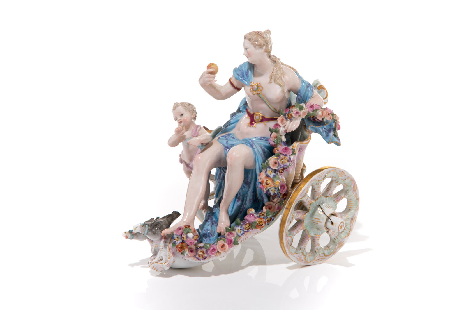 MEISSEN PORCELAIN FIGURAL GROUP VENUS & CUPID: German, 19th C. An allegorical depiction of Venus and Cupid riding in a conch form chariot, hand painted and adorned with applied floral decoration and gilded accents. Venus is shown nude, with flowin