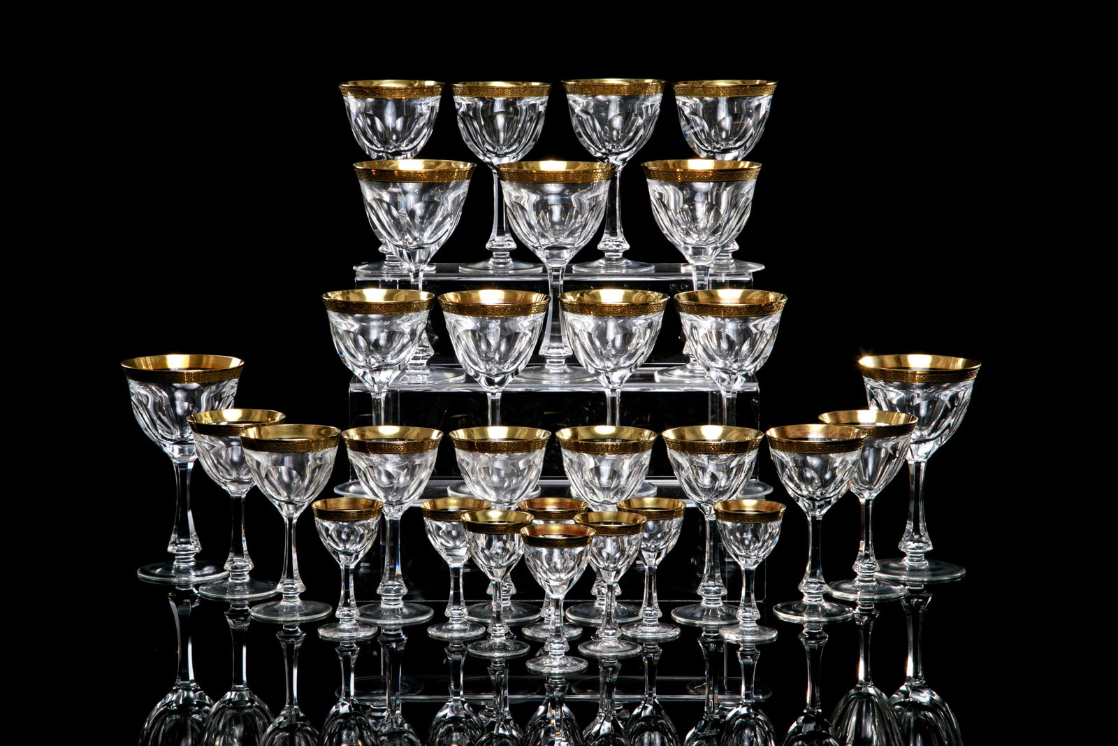 29 PIECES OF MOSER LADY HAMILTON GOLD STEMWARE: Clear cut glass, each decorated with an ornate gold encrusted band along the top and a knopped stem. Many with etched mark to base.29 stems total in various sizes, comprising: Eight white wine glass 1