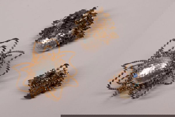 THREE VINTAGE MIRIAM HASKELL BROOCHES: Two with faux pearl and ornate gilt decoration, the third is a rhinestone set basket.