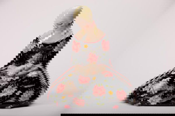 LENCI ITALY HAND PAINTED POTTERY FIGURE: Of a seated girl in a floral dress with two doves on her lap, marked Lenci, Made in Italy FV. H 17.5 cm. (6 7/8 in.)