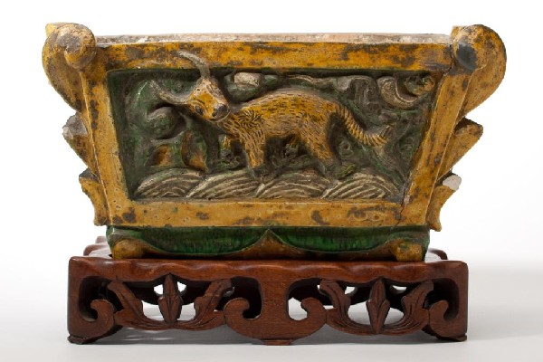 CHINESE SANCAI POTTERY INCENSE POT MING: Rectangular with a figure of a water buffalo in relief. Green and yellow glaze. Late Ming period. Repairs. W 32 cm (12 1/2in.)