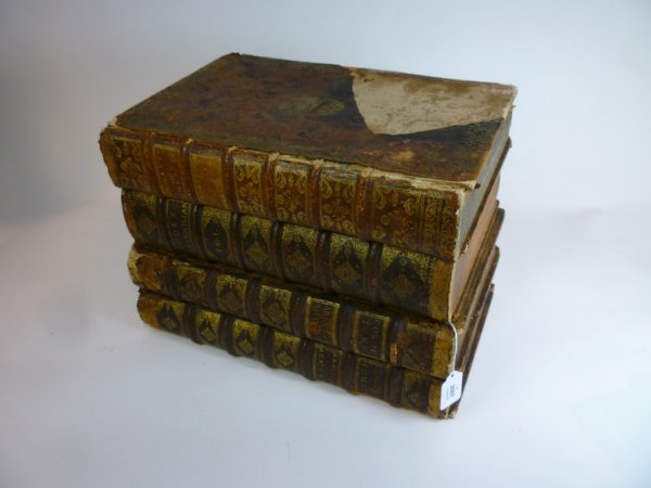 LEATHER BOUND 19TH CEN BOOK-FORM CAVE A LIQUEUR: Cave a liqueur built of four large hollowed books with two gilt decorated glass decanters and eight thimble glasses. H 27.5 cm. (10 3/4 in.)