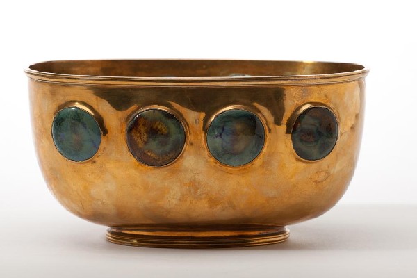 BRASS ARTS & CRAFTS BOWL WITH RUSKIN INSERTS: Hand hammered Arts & Crafts footed bowl, English or Scottish school, possibly for Liberty & Co. with eight Ruskin pottery inserts. Base punched with maker's mark F.K.S. W 20.5 cm. (8 1/8 in.)