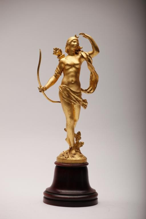 GILT METAL DIANA THE HUNTRESS ON WOOD STAND: Standing with her bow and arrow, signed base. H 27 cm. (10 5/8 in.)