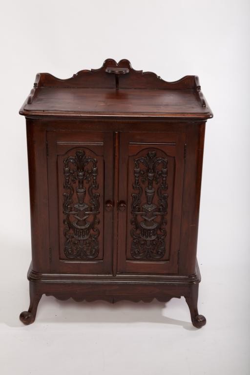 EDWARDIAN PINE AND WALNUT TWO DOOR MUSIC CABINET: With overall dark walnut finish. Heavily decorated doors and sides. Single interior shelf. H 105cm (41 1/4in.)