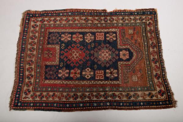 ANTIQUE CAUCASIAN PRAYER RUG: Kazak with blue and red ground with geometric circle border. 4' 5" x 3' 4"