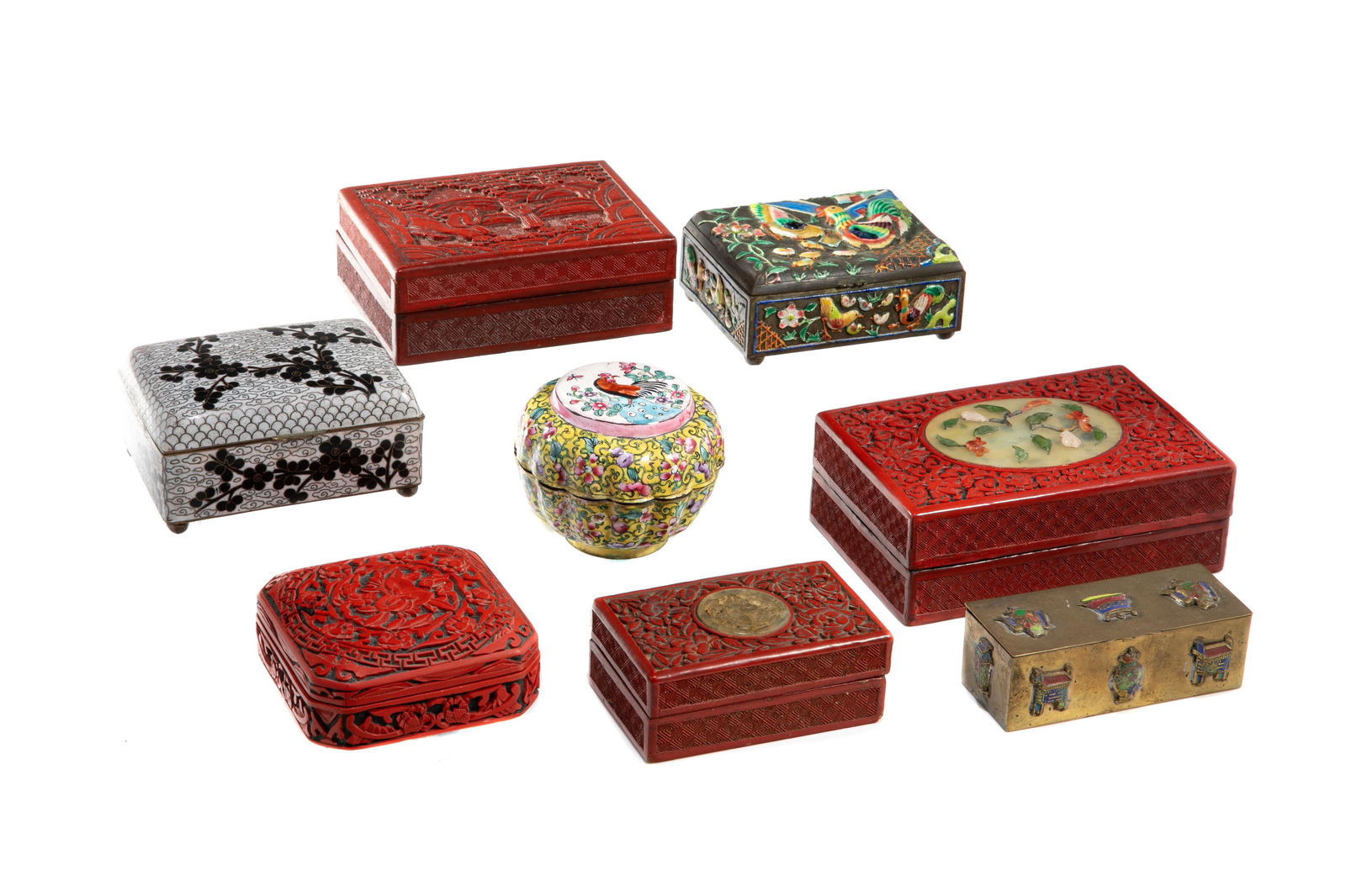 EIGHT ASSORTED CHINESE DECORATIVE BOXES: Eight Chinese decorative boxes including four in red lacquer, one cloisonne, two with canton enamel decoration, and one brass box. H 6 x W 15.5 x 10.2 cm (2 1/4 x 6 x 4 in.) and smaller.