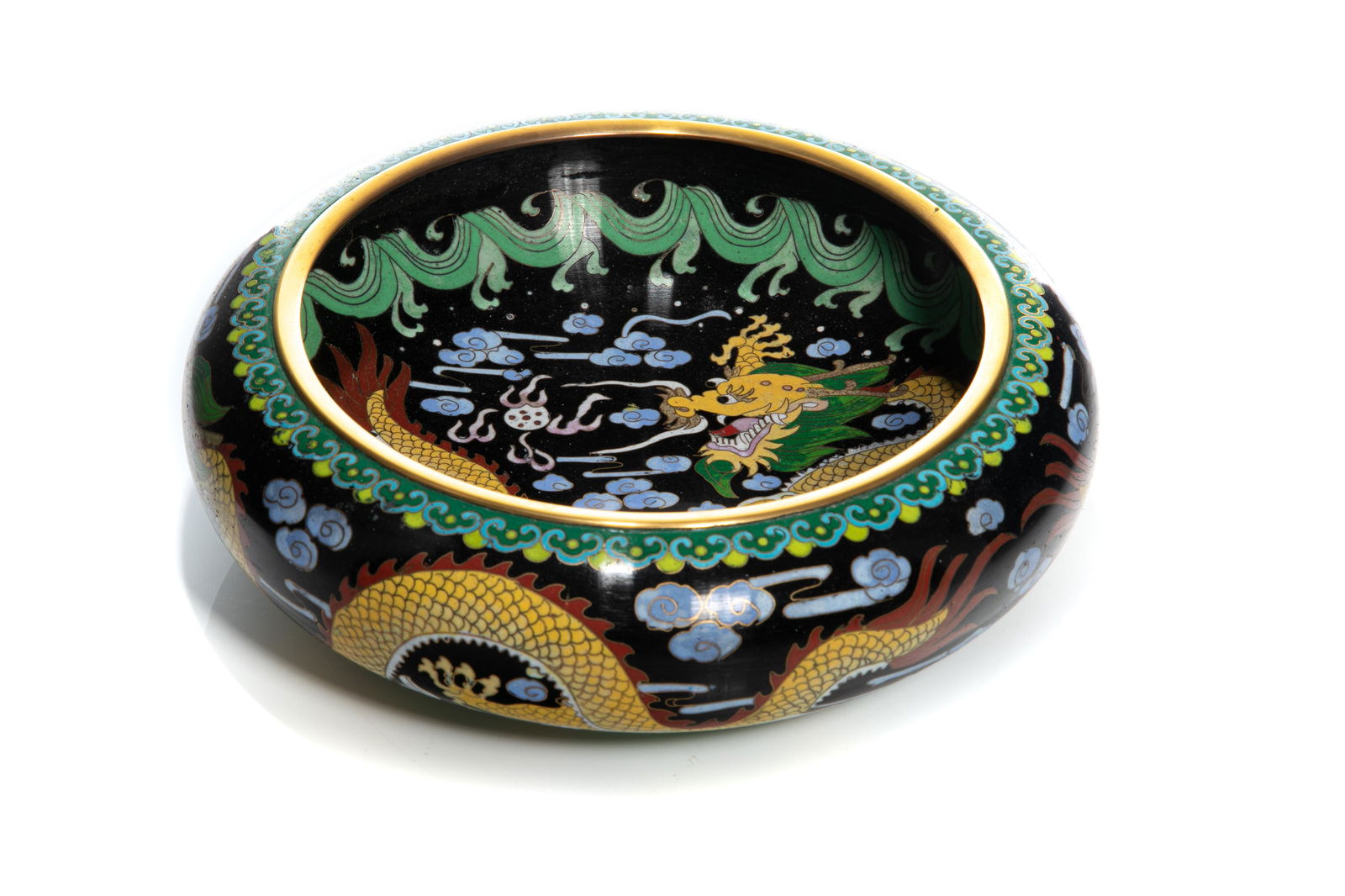 CHINESE CLOISONNE DRAGON BOWL: Chinese, 20th century, featuring yellow dragons on black ground, with green waves, on low wide body, with turquoise base, and gilt metal rim. Dia 25.5cm (10 in)