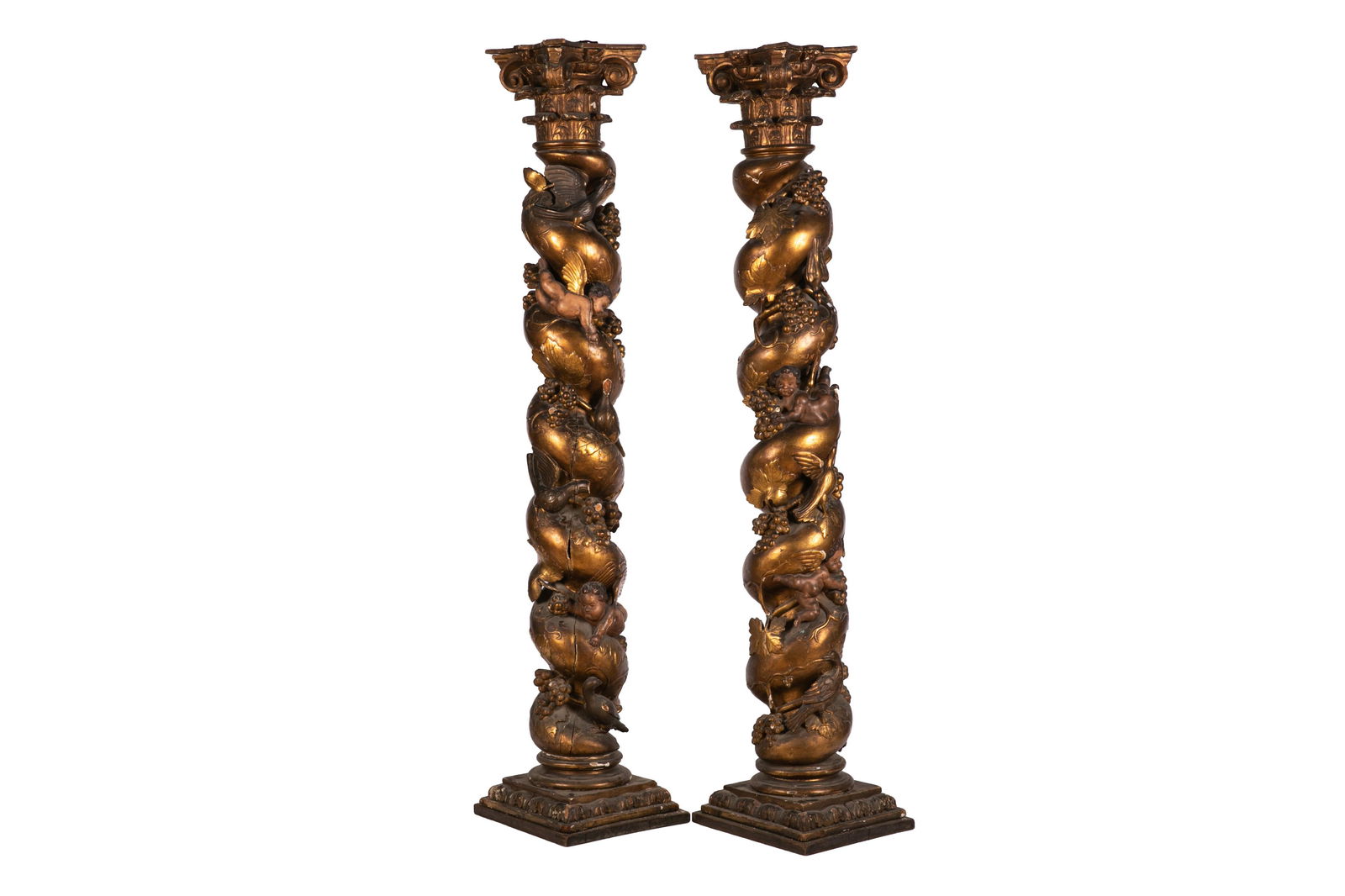 18th C ITALIAN ANTIQUE CARVED GILTWOOD COLUMNS: Two large helical columns, similar in form to the old Solomonic columns of the Baldachin at St Peter's Basilica. Topped with compound columns and decorated with carved fruit and grapes, birds,and putt