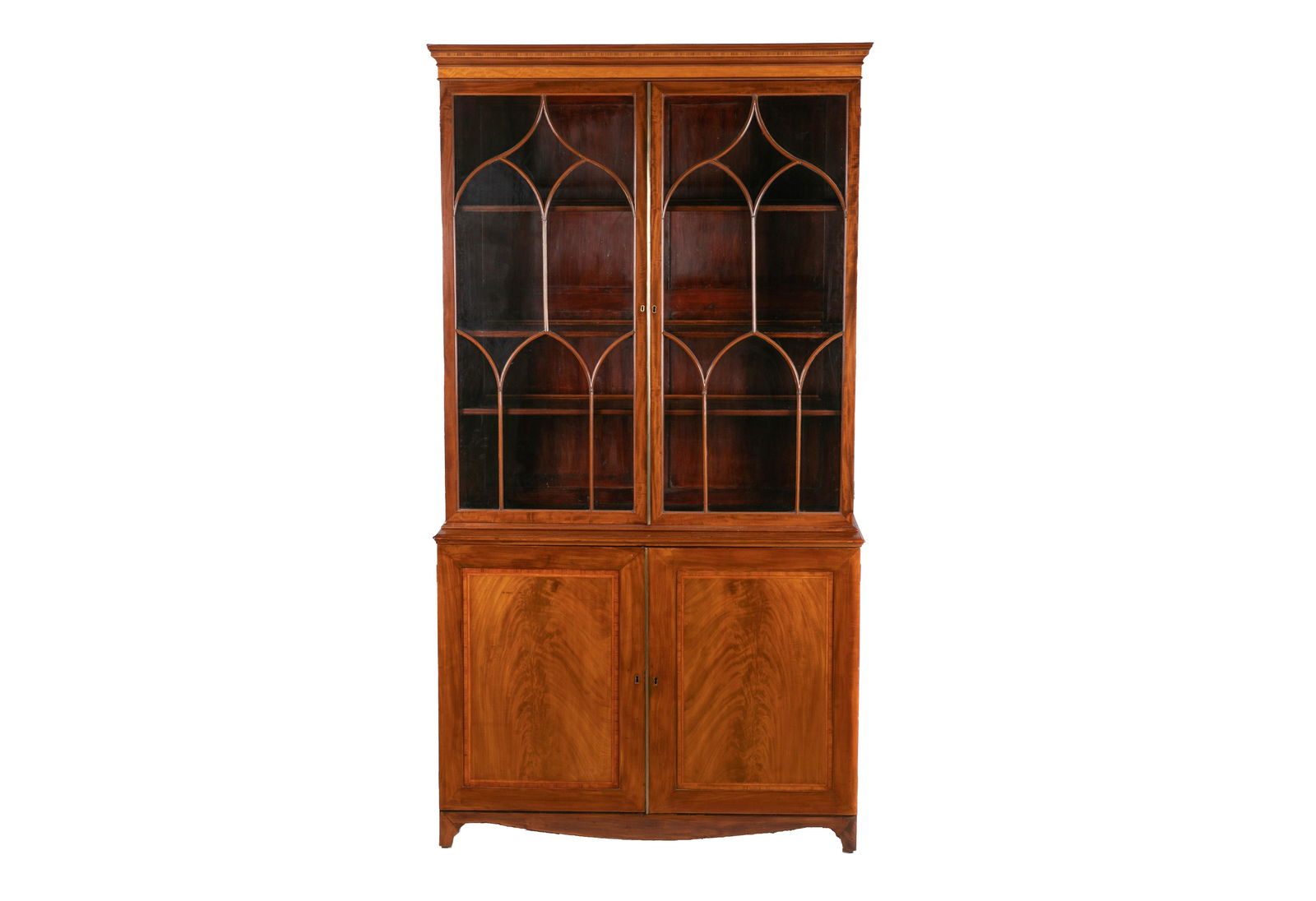 FINE GEORGE III FLAME MAHOGANY GLAZED BOOKCASE: Upper section with ogee-form intersecting tracery in glazed upper doors. Lower section with two cupboard doors that open to reveal three shelves. H. 89 1/2" W. 48 3/4" D. 18 1/4"