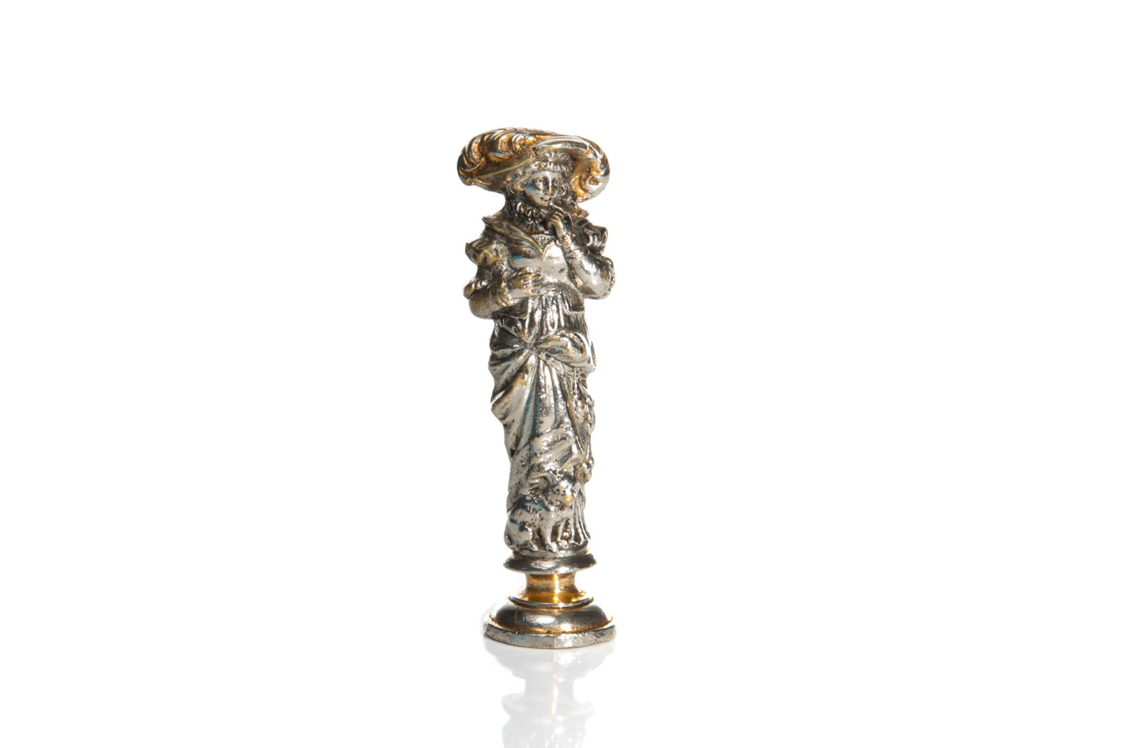 19th C FIGURAL SEAL: The decorative handle which is plated in gold and silver depicts a female figure in historical dress with a dog at her feet. The metal matrix features two shields surmounted by a crown. Appears to be 