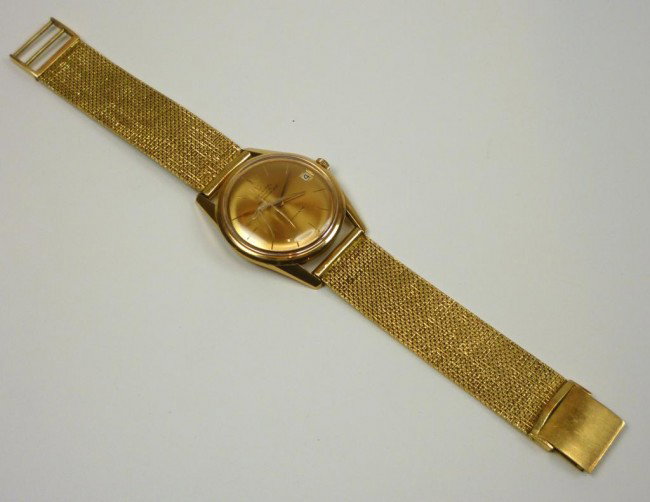 UNIVERSAL GENEVE POLEROUTER 18K GOLD WRISTWATCH: With gold face and wire mesh band. Diameter of case 3.6 cm. 18k yellow gold band. 85 grams total weight.