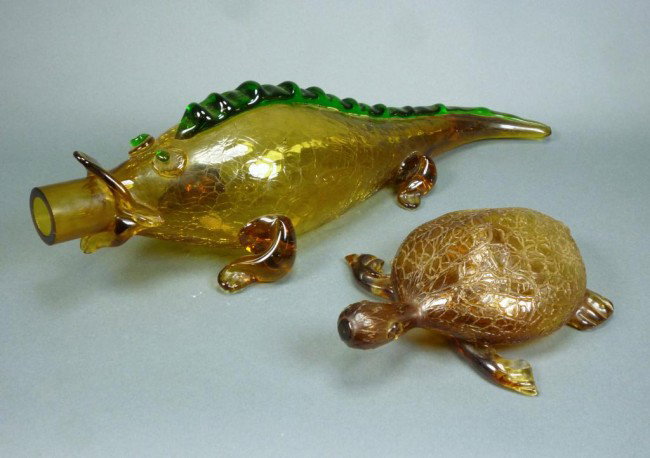 TWO POSSIBLY BOHEMIAN GLASS ANIMALS: The first, possibly Moser, cracked ice amber glass lizard with applied green spine, shaped as a decanter. The second, a crackle amber glass turtle with applied blown feet. L of lizard 42 cm. (16 1/2 i