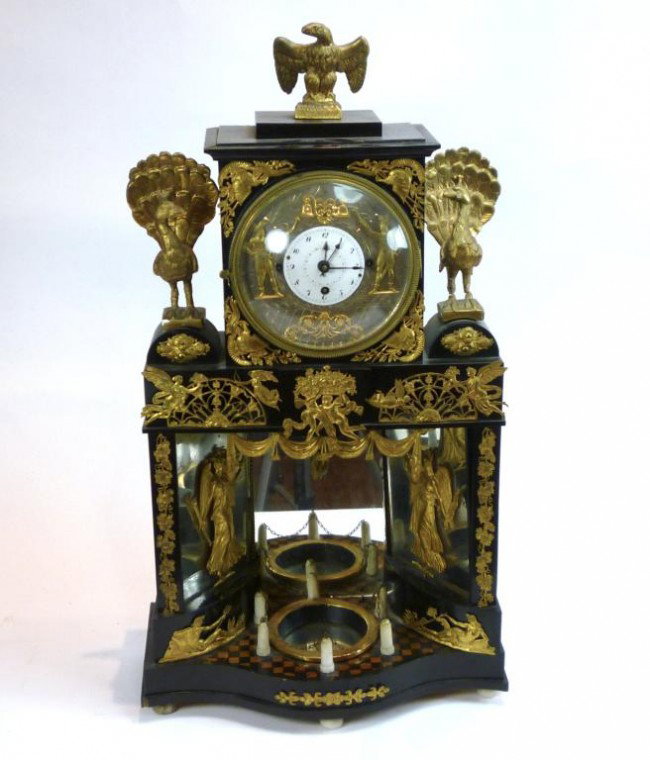AUSTRIAN BIEDERMEIER LACQUER AUTOMATON CLOCK: With silvered and enemal dial and applied striking figures. Gilt metal mounts and gilt figures of peacocks and an eagle. The base with mirrors, miniature fountain and checkerboard style terrace. Origi