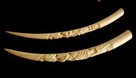 LARGE PAIR OF AFRICAN IVORY CARVED TUSKS: Pair of West African Ivory Tusks, 20th century carved with figures of woman. L 78 cm (30 3/4").