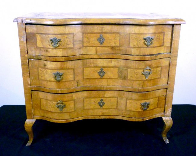 19TH CENTURY GERMAN BLONDE WALNUT CHEST OF DRAWER: Serpentine fronted blonde inlayed walnut veneered mid sized chest of drawers (3). With brass pulls and escutcheons. Cabriole legs. Veneer losses.