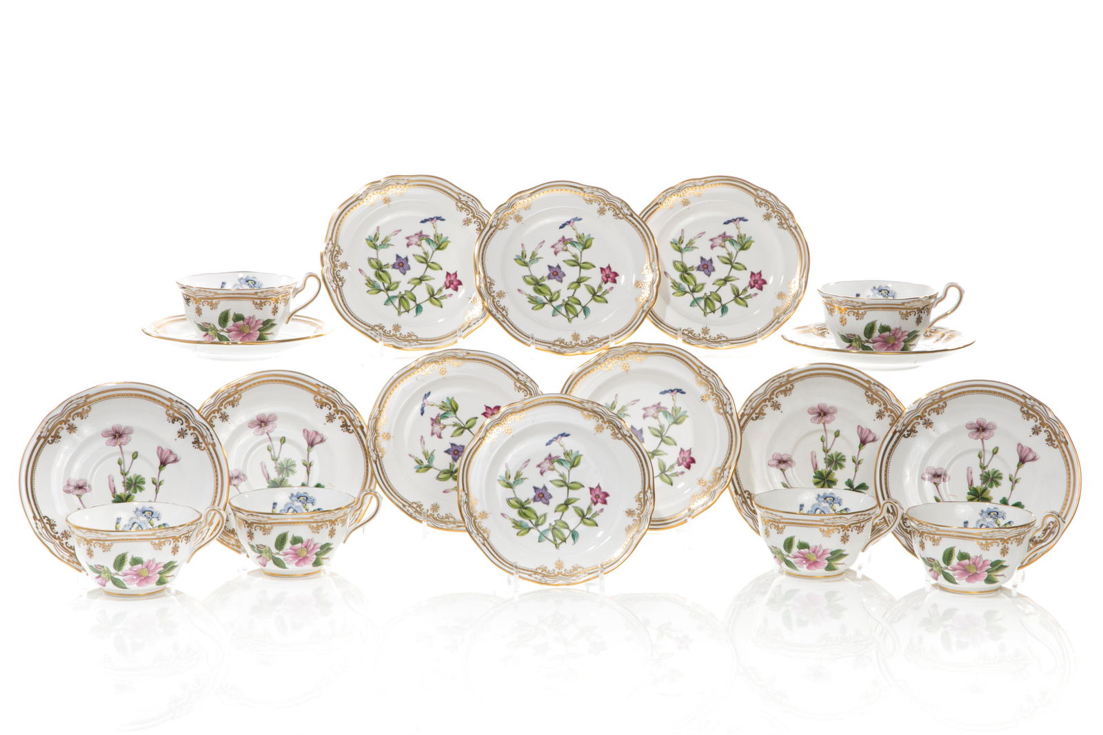 SIX SPODE STAFFORD FLOWERS TRIO SETS: Tea cups with Polygala, Thunberia & Camellia flowers, saucers Tachiadenus flowers and bread & butters with Oxalis flowers. Dia. of plate: 6 1/8 in.