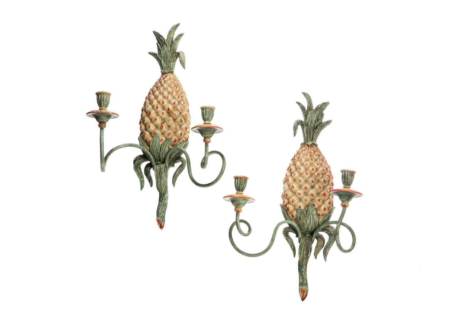 PAIR OF WOOD CARVED PINEAPPLE SCONCES: A pair of decorative two arm sconces with central pineapple motif, painted cream with red and green. H. 48 cm (18 7/8 in).