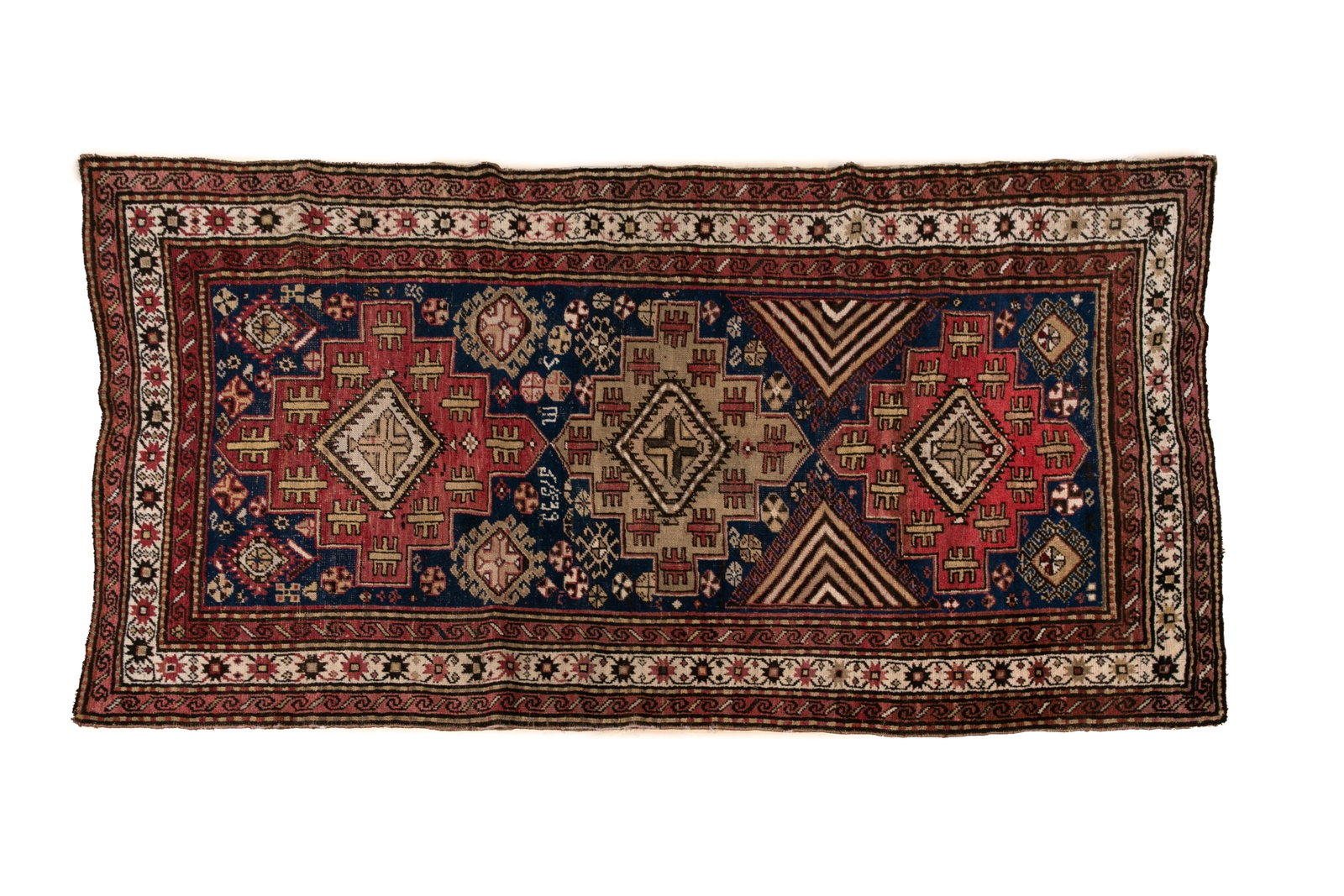 SIGNED ARMENIAN RUG: On blue ground with three cross medallions, and a main border of white. 8' 2" x 4'