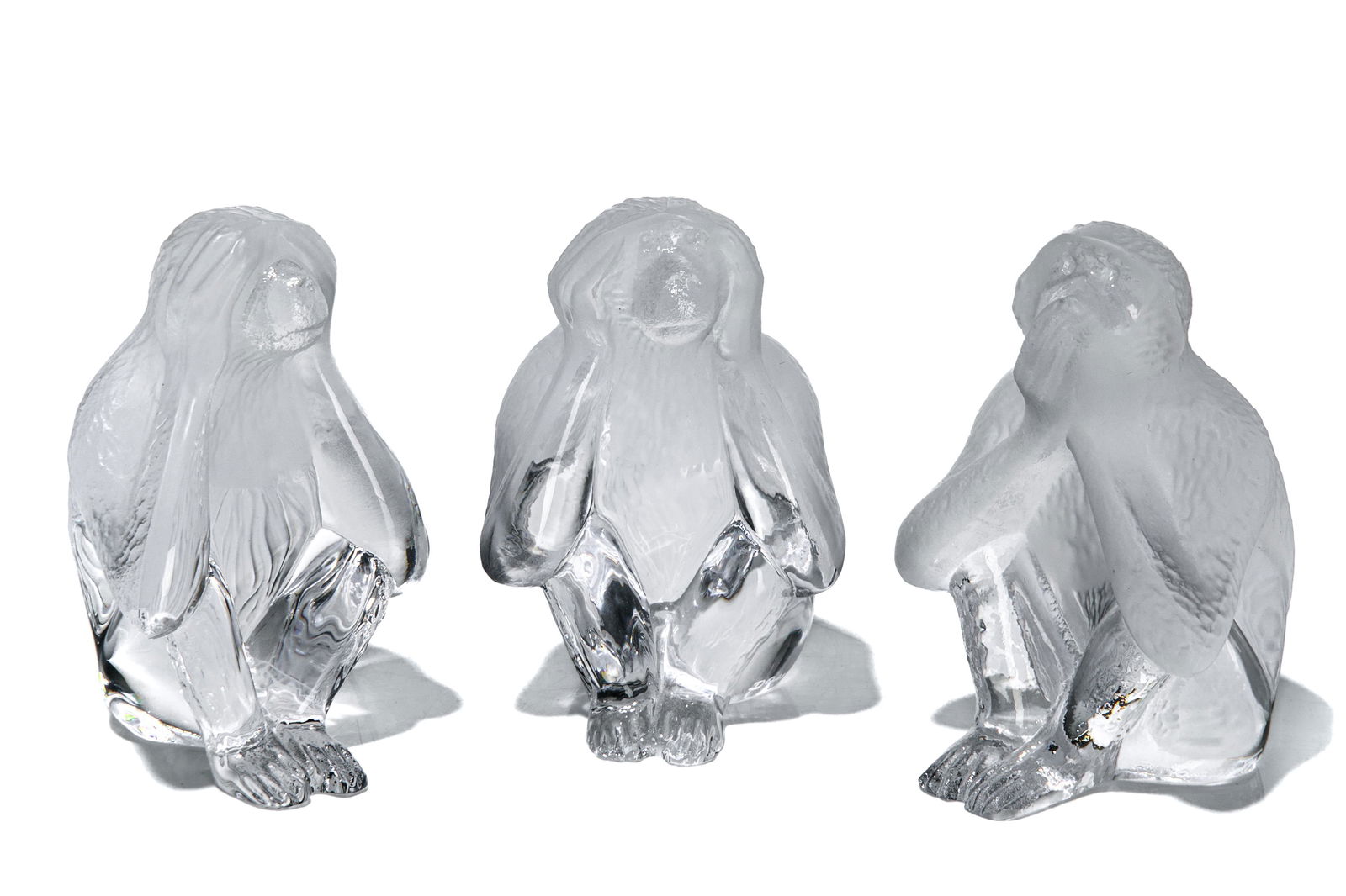 THREE DAUM NANCY FROSTED GLASS MONKEYS: Group of Daum Nancy frosted glass monkeys. Each depicted seated, one covering its eyes (See no evil), a second covering its ears (Hear no evil) and a third covering its mouth (Speak no evil).Each sign