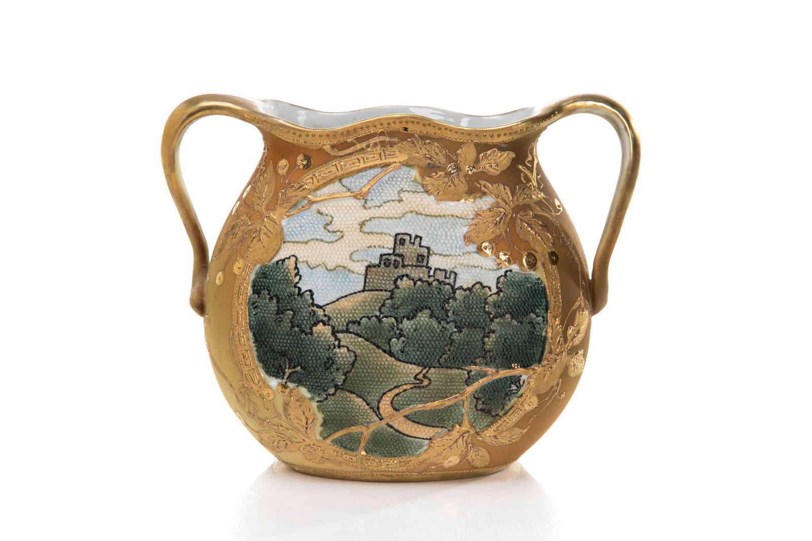 NIPPON TWO HANDLED TAPESTRY PORCELAIN VASE: Art Nouveau form with a central needlepoint style ground painted with a castle and rolling hills, gilded vines on the reverse. Japanese, blue maple leaf mark, early Noritake. H. 15.2 cm (6 in.)