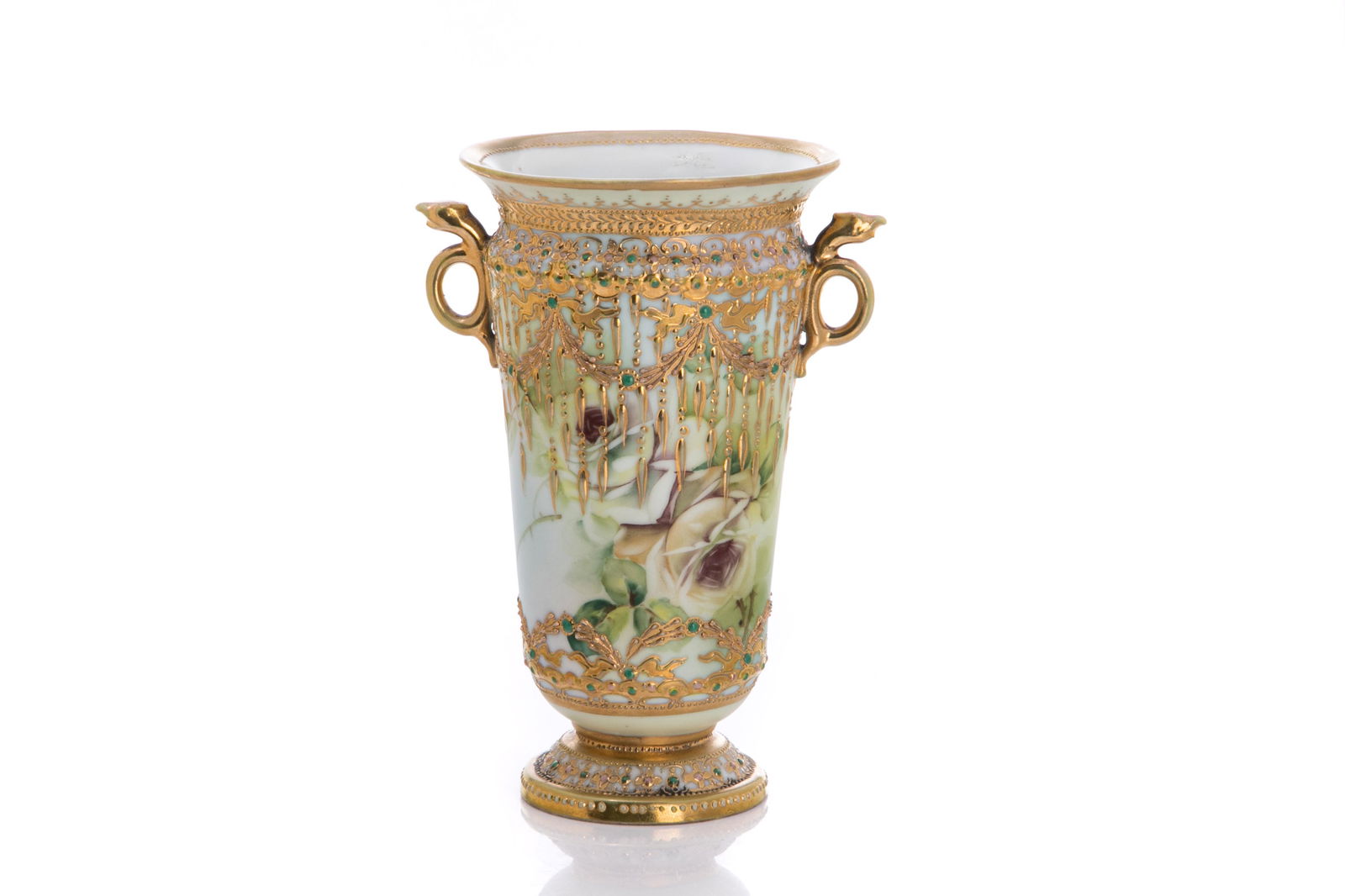 NIPPON SNAKE HANDLED JEWELLED PORCELAIN VASE: Texas rose style ground with white painted roses beneath gilded swags and drops, accented with turquoise enameling. Japanese, blue maple leaf mark, early Noritake. H. 20 cm (7 7/8 in.)