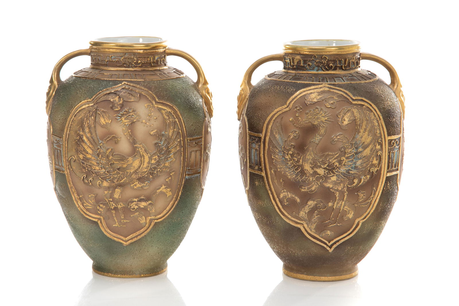 NEAR PAIR OF NIPPON BURNISHED STONEWARE VASES: Textured brown to green ground with low relief moriage cartouches accented with phoenix and flowers, rounded body and handles. Japanese green M in wreath mark and Noritake mark. H. 18.4 cm (7 1/4 in.)