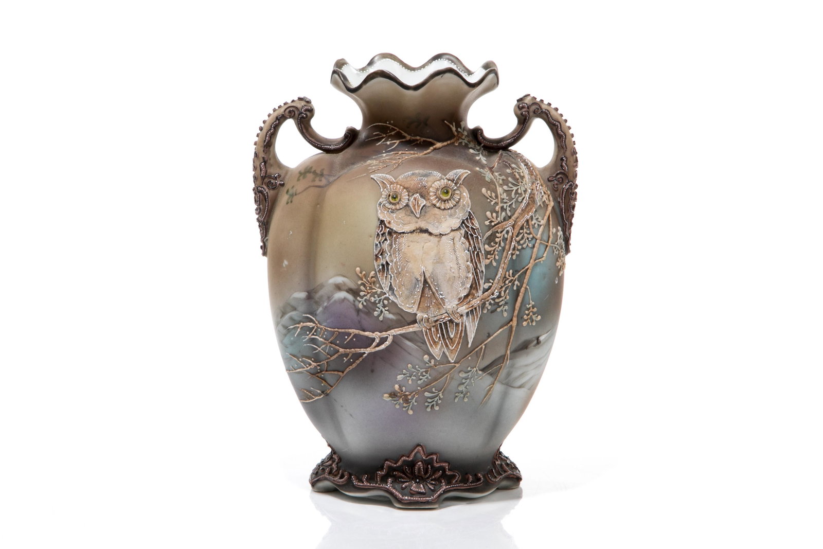 NIPPON FIGURAL MORIAGE PORCELAIN VASE: Two handled vase with ruffled rim. Painted with a heavily enameled and moriage decorated owl with yellow glass eyes, perched on a branch with mountainous landscape in the background. Japanese green ma