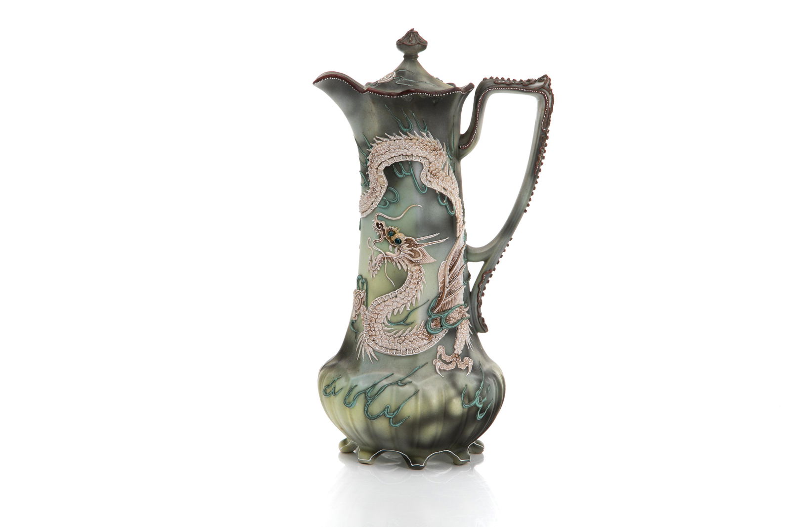 NIPPON MORIAGE FIGURAL PORCELAIN COCOA POT: Mottled yellow to black ground, footed body. Moriage and enamel decorated dragon and pearl with blue glass eyes surrounded by flames. Japanese, blue maple leaf mark, early Noritake. H. 30 cm (11 3/4 i