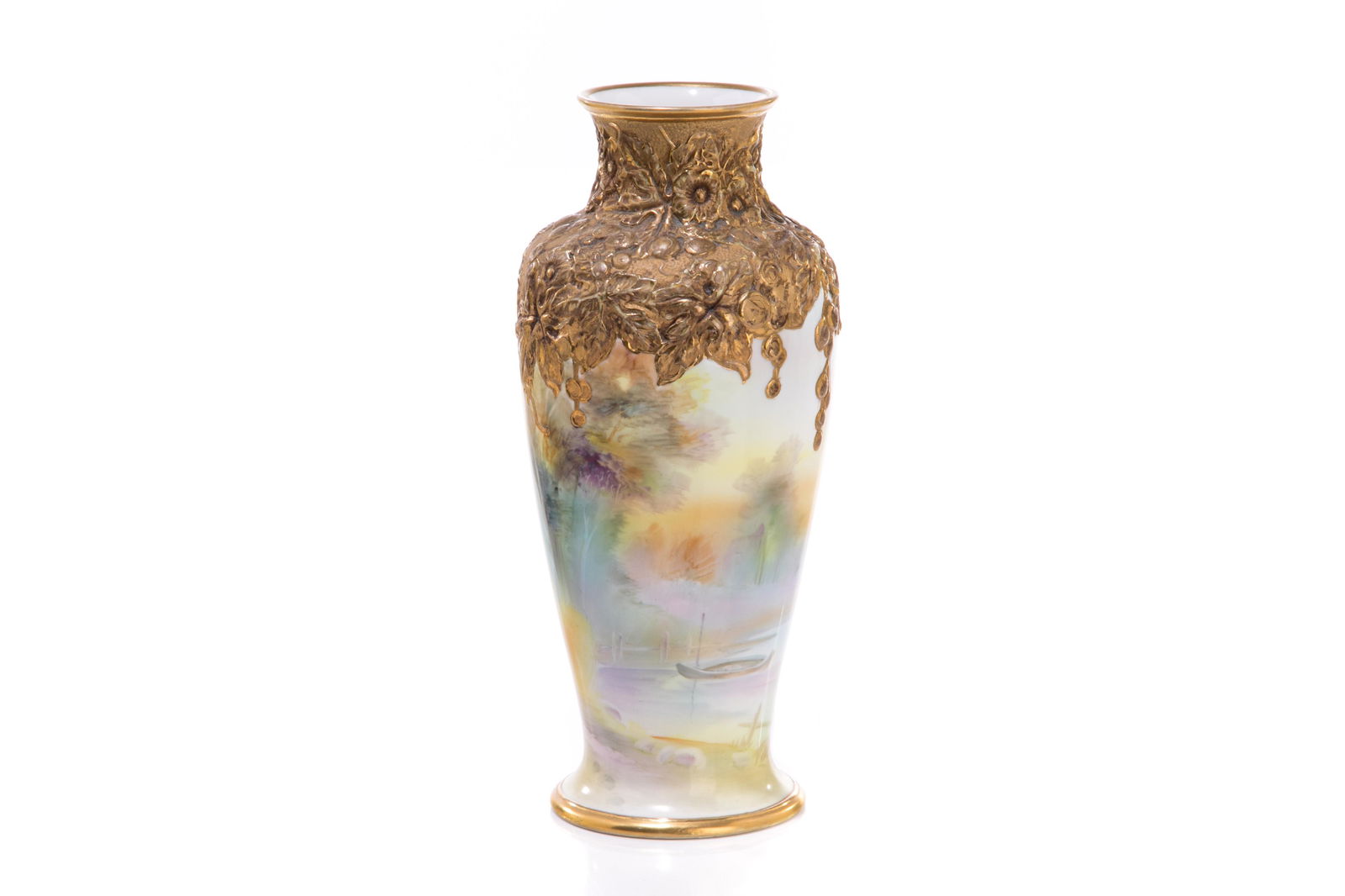 NIPPON MOLDED SHOULDER PORCELAIN VASE: Gilded molded shoulder with flowers and grape vine decoration, fishing landscape scene on the body. Japanese, gold M in wreath, early Noritake. H. 25 cm (7 7/8 in.)