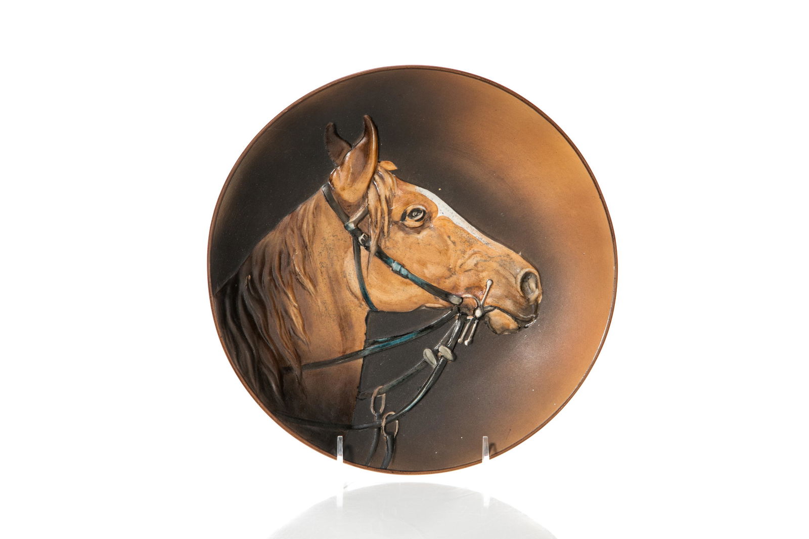 HORSE NIPPON PORCELAIN WALL PLAQUE: Mold blown, hand-painted Nippon porcelain wall plaque of a horse wearing a bridle, dark brown to orange gradient. Japanese, green M in wreath, early Noritake. Dia. 27.5 cm (10 3/8 in.)