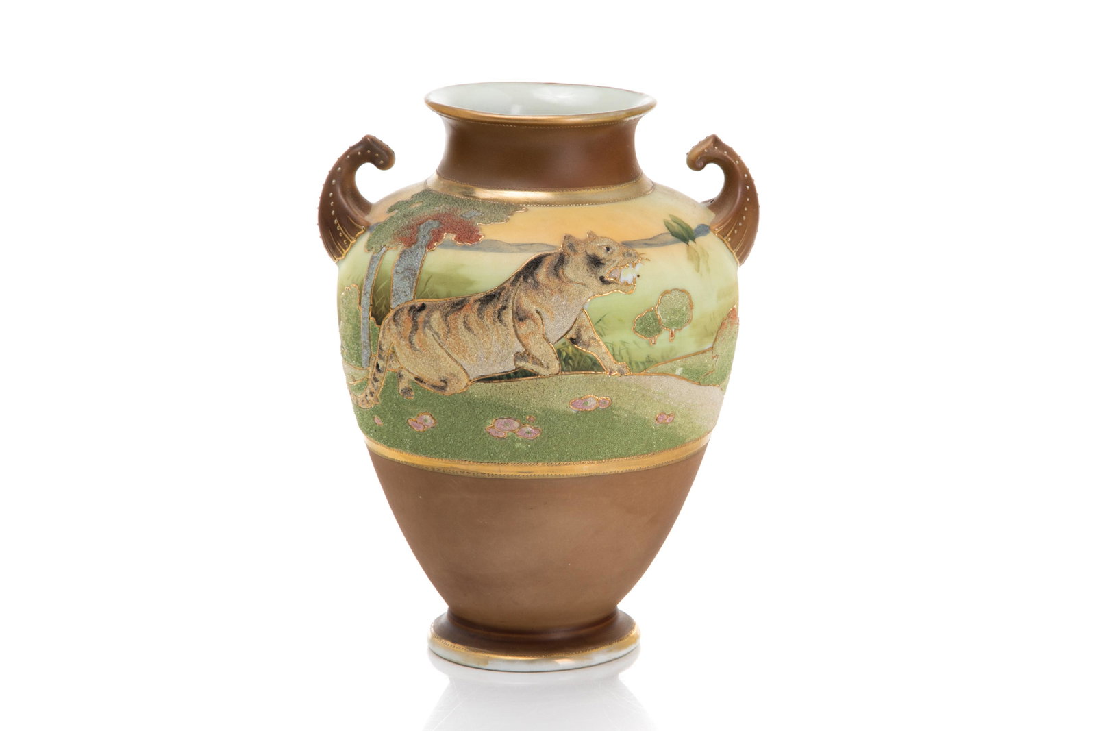 NIPPON CORALENE FIGURAL PORCELAIN VASE: Brown ground two-handled vase with a central landscape, painted band accented with a Coralene tiger and tree. Japanese, Kinran patent mark to base. H. 23 cm (9 in.) Provenance: Label to underside for 