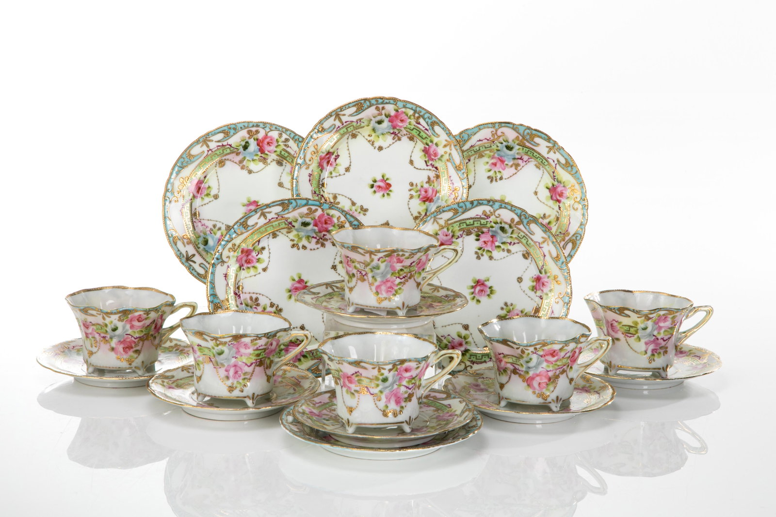 SIX NIPPON PORCELAIN CUP & SAUCER TRIOS: The teacups and saucers hand painted with blue and pink roses, accented with gilding. Japanese, hand painted mark to underside. Dia. of sandwich plate: 16 cm (6 1/4 in.)