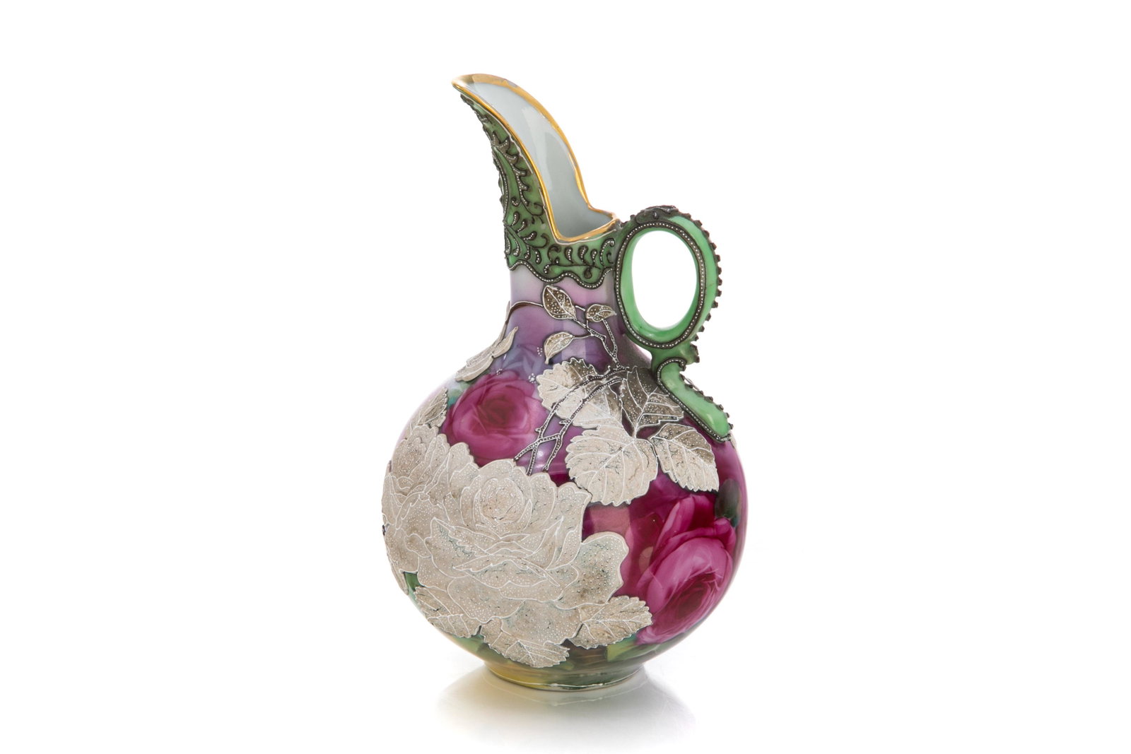 NIPPON ROSE & MORIAGE PORCELAIN EWER: The body hand painted with pink roses accented with heavy white slip glazing and foliate moriage enameled decoration on the spout and handle. Japanese, green I. E. & C. Co. mark. H. 19 cm (7 1/2 in.)