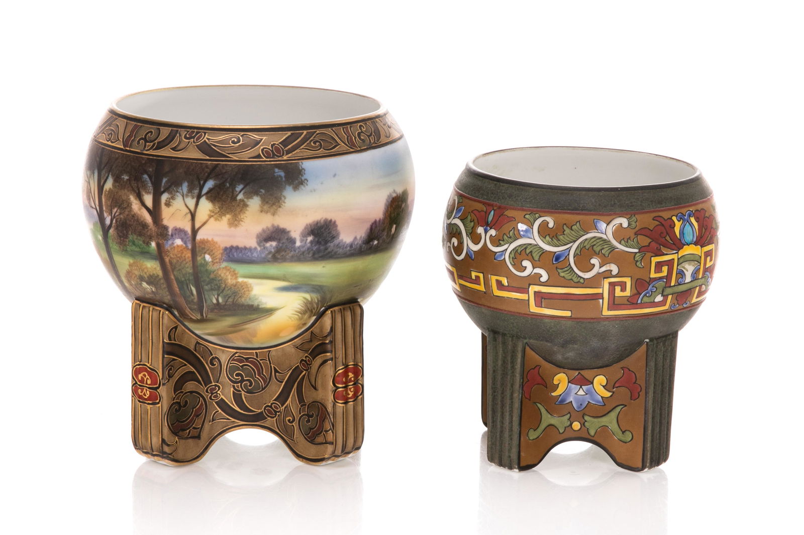 TWO NIPPON PORCELAIN JARDINIERES: Two bowls with integrated stands. Matte glazed with painted natural scene, gold decoration on stand. Together with a smaller bowl. Japanese, green M in wreath mark, early Noritake. H. of tallest: 18 c
