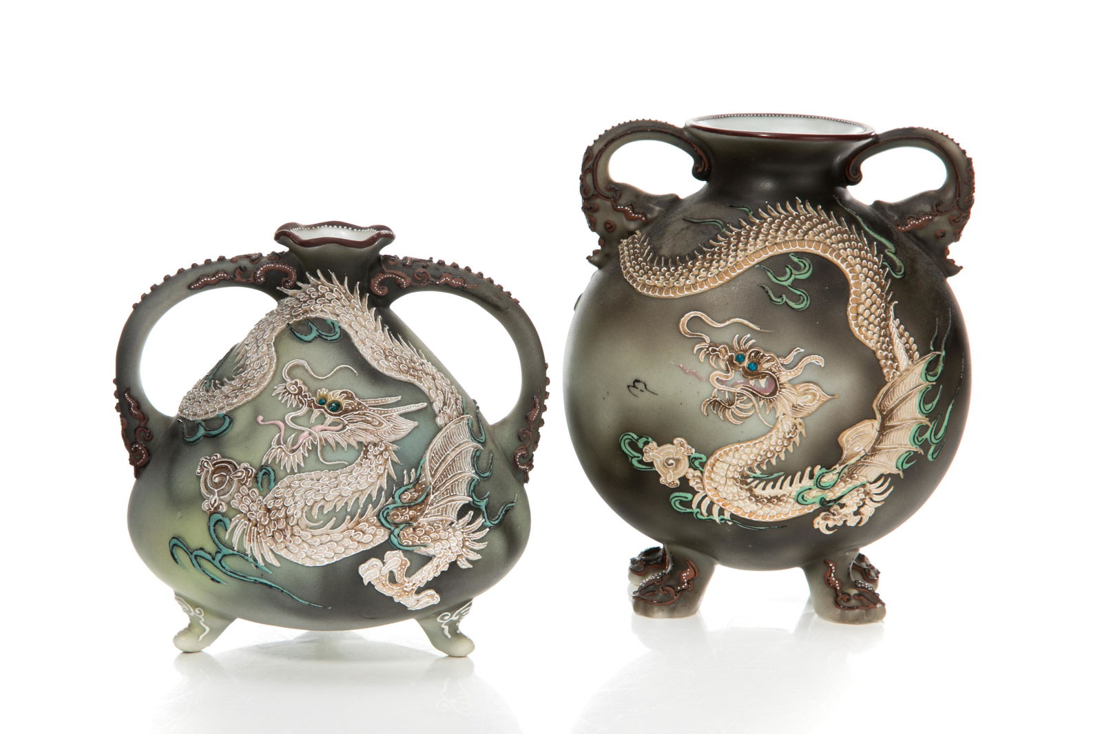 NIPPON DRAGON MORIAGE PORCELAIN VASE: A matte glazed, hand-painted Nippon porcelain twin handled vase with dragon moriage design and smoky grey background, sat on four claw feet. Japanese, green M in wreath mark, early Noritake. H. of tal