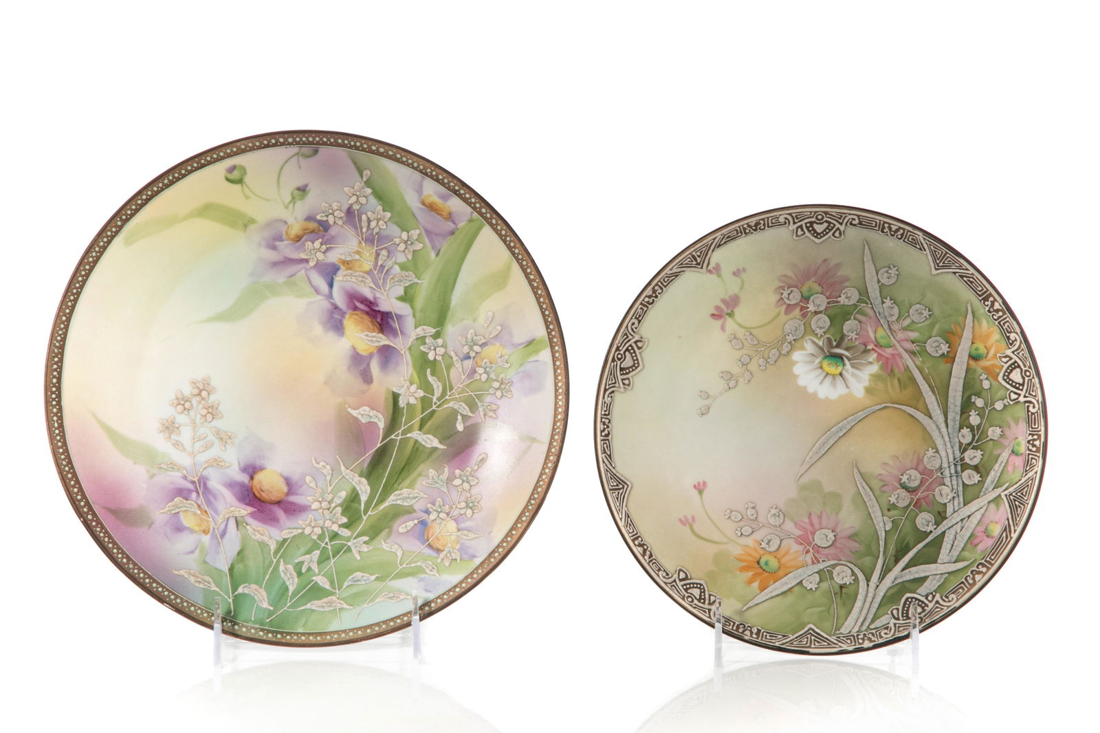 TWO NIPPON PORCELAIN WALL PLAQUES: Two hand-painted Nippon porcelain wall plaques depicting floral designs, white moriage accents to both. Japanese, green M in wreath, early Noritake. Dia. of largest: 25 cm (9 7/8 in.)