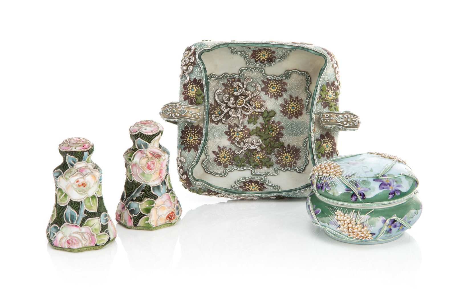 FOUR NIPPON MORIAGE PORCELAIN PIECES: Four moriage decorated pieces including one two-handled cache pot with brown flower and spiral motif, a bonbonniere with stylized dandelion and violet spray, and salt and pepper shakers withpeach and 