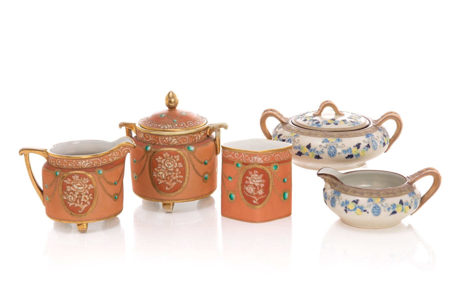TWO NIPPON PORCELAIN CREAM & SUGAR SETS: Three matching Nippon porcelain orange matte glazed pieces, including one cigarette holder, one sugar bowl with lid, and one creamer. Together with a matching cream jug and covered sugar withmoriage d