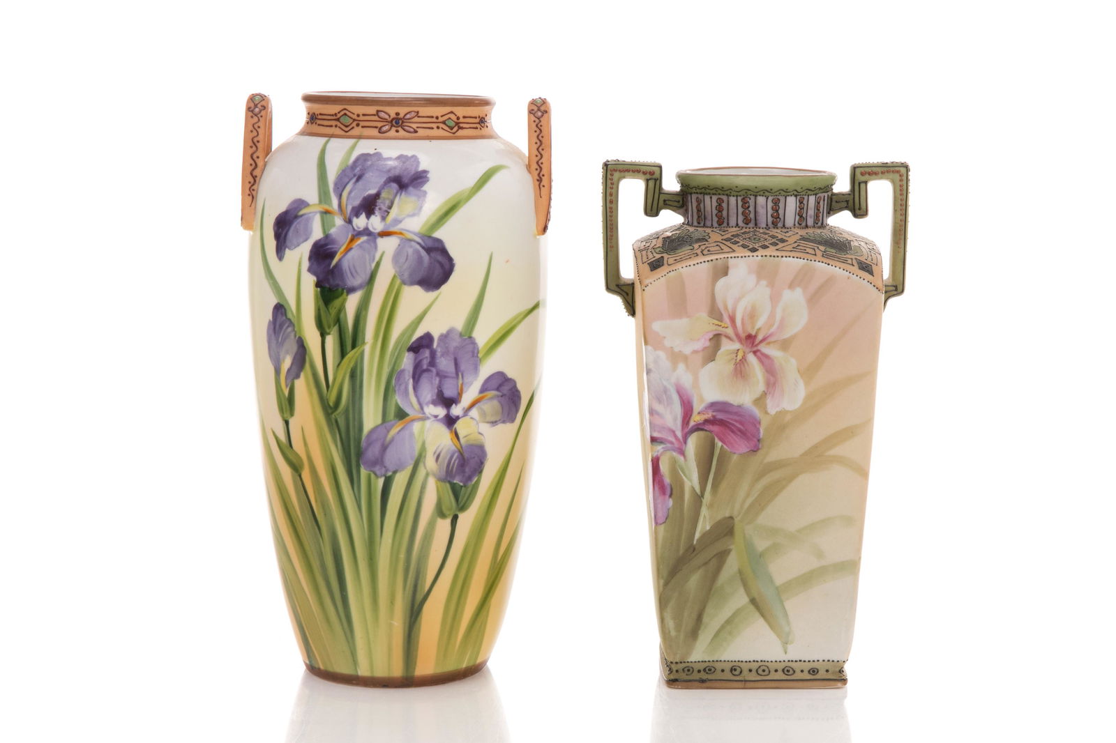 TWO NIPPON PORCELAIN IRIS VASES: Two Nippon porcelain twin- or two-handled vases with hand painted irises and moriage decorated tops and handles. One matte glaze vase with pink irises, Japanese, green M in wreath mark, earlyNoritake;