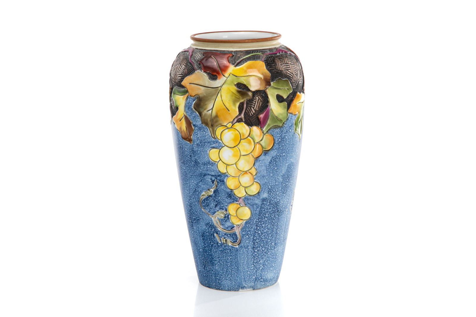 NIPPON AMERICAN INFLUENCED ARTS & CRAFTS VASE: Raised molded in relief grape & vine cluster porcelain vase on a mottled blue ground, basket weave enhancing on the shoulder and colourful glazed grapes. Japanese, green M in wreath mark,early Noritak
