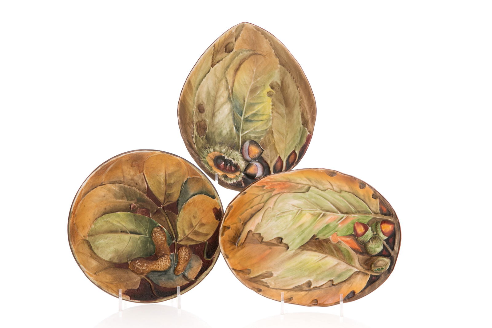 THREE NIPPON PORCELAIN CANDY DISHES: Three hand-painted Nippon porcelain mold blown candy dishes, matte glazed, featuring autumnal leaves and nuts in relief. Japanese, green M in wreath mark, early Noritake. Dia. of largest: 20 cm (8 in.
