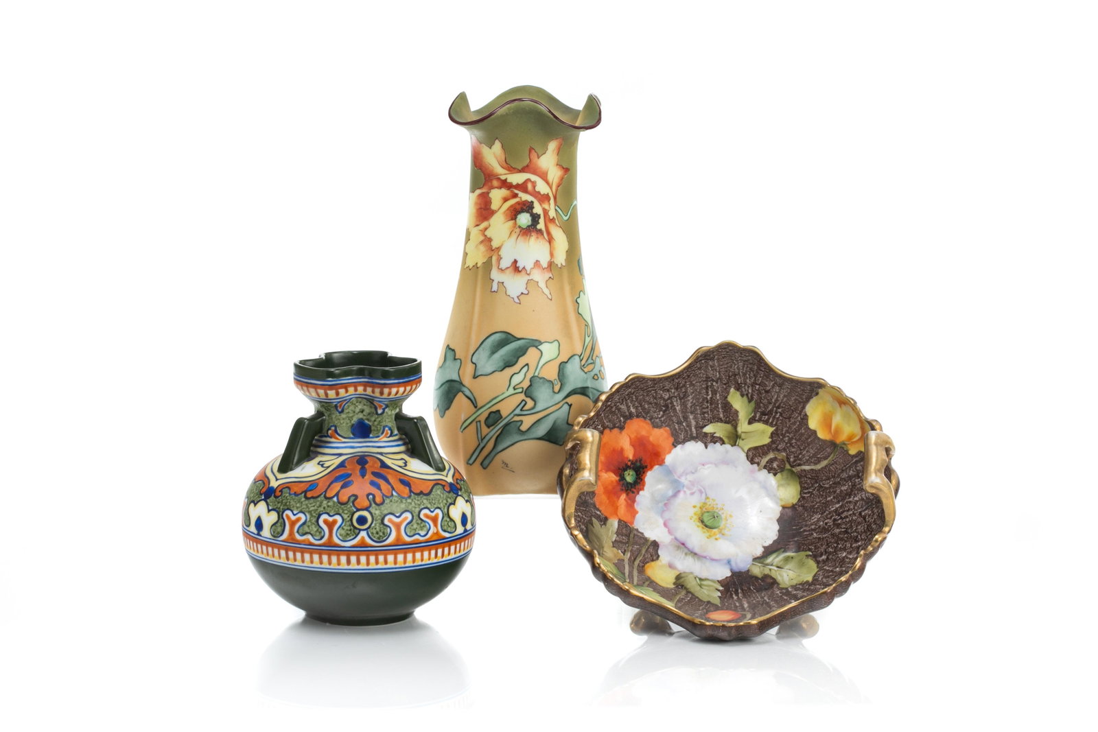 THREE NIPPON PORCELAIN PIECES: Including a gradual orange matte glazed vase with hand painted flowers, and a three handle vase in a Dutch Gouda-style decoration. Together with a two handle bowl, on four gilded feet, hand paintedpop