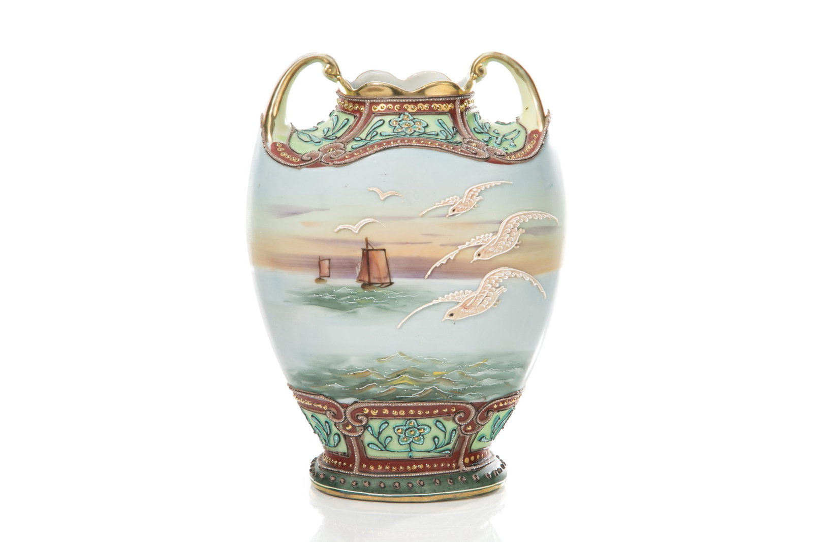 NIPPON TWO HANDLED MORIAGE PORCELAIN VASE: Matte glazed baluster form body with hand painted scene of sailboats, moriage seagulls and decoration, gilded handles and rim. Japanese, blue I. E. & C. Co mark. H. 19 cm (7 1/2 in.)