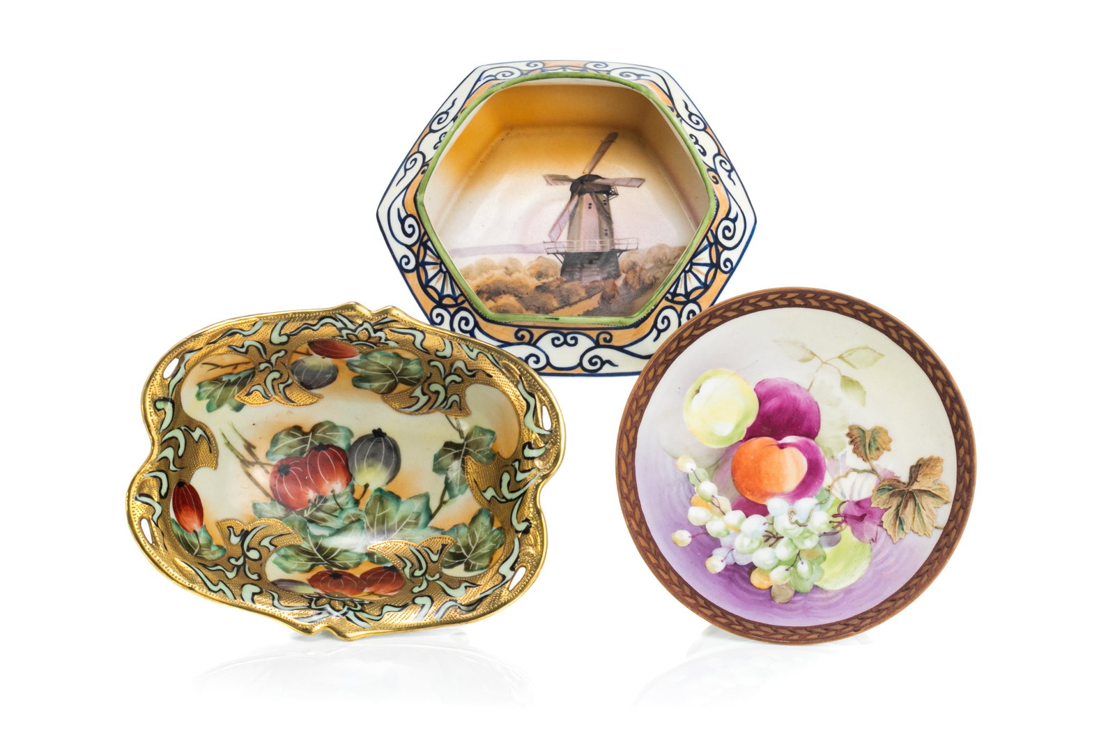 THREE NIPPON PORCELAIN BOWLS: With hand painted rose hips, gilded decoration, on four gilded feet. Together with a bowl with hand painted windmill scene, and a bowl on an integrated stand with hand painted fruit scene. H. of talle