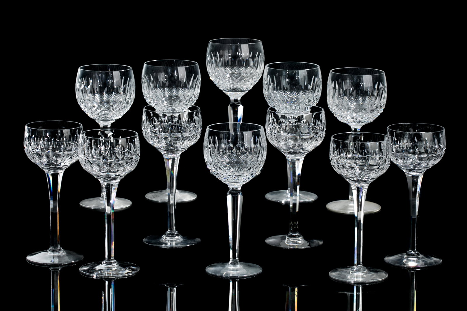SET OF TWELVE CRYSTAL HOCK WINE GLASSES: Including six crystal Waterford Colleen pattern hock wine glasses with marks to base, and six smaller hock wine glasses, unmarked. 20th C. H. of tallest: 19cm (7 1/2in)