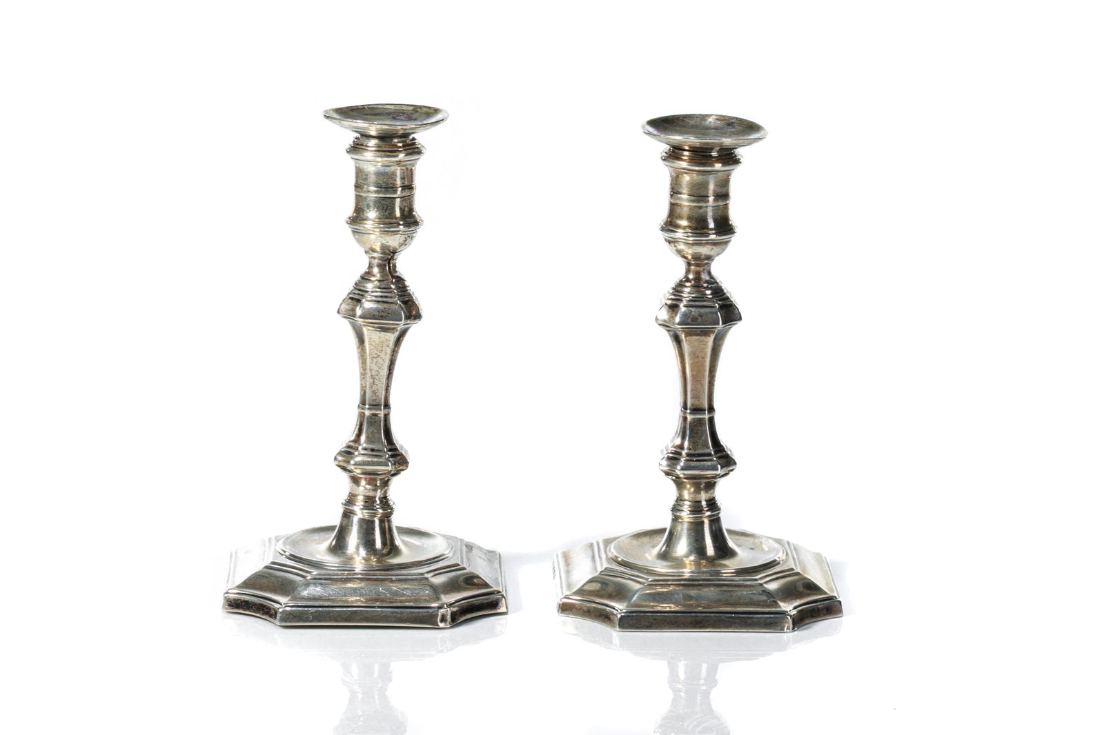PAIR OF ENGLISH SILVER TAPER STICKS, 168g: A pair of English sterling silver taper sticks in the George II style. Hallmarked for Hawksworth and Eyre Co., Sheffield, 1905. Bases are filled. H. 8.5 cm (3 3/8 in.) Weight: 168g (bases are filled)